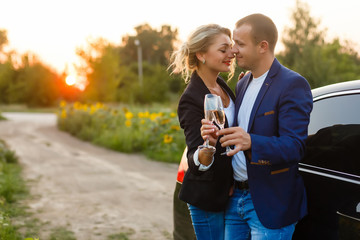 Obraz premium The charming couple in love with glass of champagne