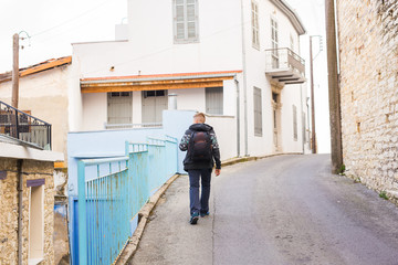 Young hipster man traveling backpacker outdoor. Travel concept.