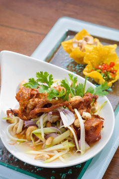 Thai spicy salad with deep fried soft shell crab and sliced green mango, Yum Pu Nim in Thai cuisine