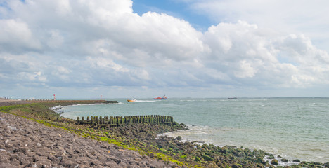 Dike protecting land against the sea in sunlight