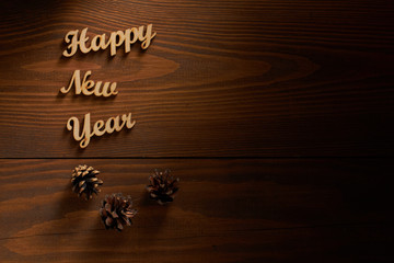 Happy New Year!/ Happy New Year! - A phrase with wooden letters on a wooden backg