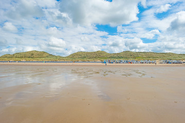 Sand dunes along a beach in sunlight in summer