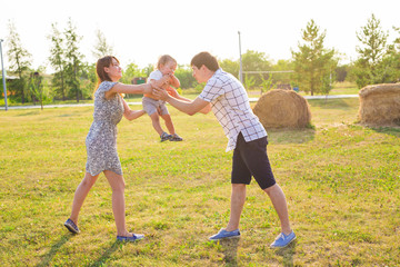 Fototapeta premium happy family in the field in autumn, play and have fun, bright evening light