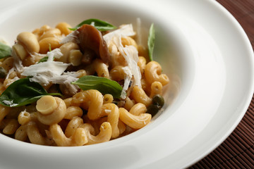 Pasta with roasted mushrooms in white plate