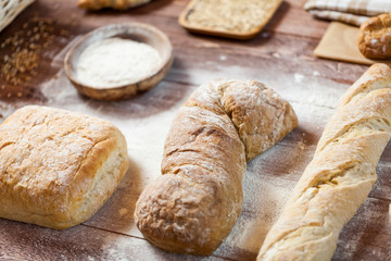 Freshly baked delicious bread on a rustic wooden table, healthy eating concept