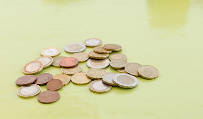 Random amount of euro coins on green table