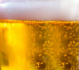 Golden bokeh picture is made of beer bubbles and natural light.