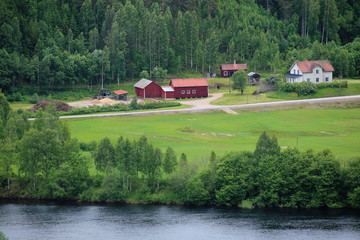 Swedish houses near Branaes in Vaermland, Sweden. The river Klaraelven can be seen