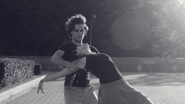 Young couple dancing on the square