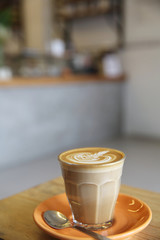 Cappuccino coffee on wood background in coffee shop