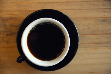 Black coffee on wood background in coffee shop