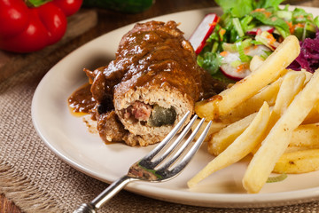 Pork roulade with french fries with salad