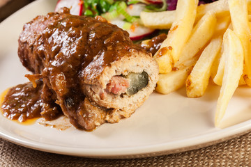 Pork roulade with french fries with salad