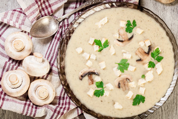 Mushroom cream soup with croutons and spices