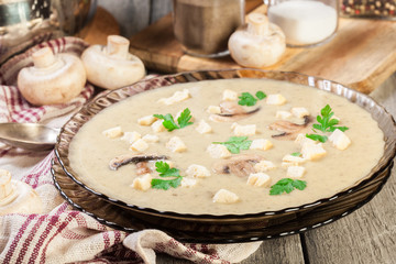 Mushroom cream soup with croutons and spices