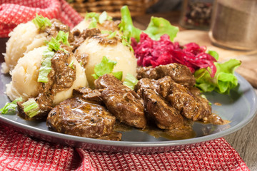 Pork tenderloin in mushroom sauce with boiled potatoes and salad..Pork tenderloin in mushroom sauce with boiled potatoes and salad..Pork tenderloin in mushroom sauce..