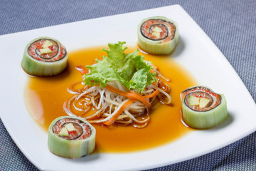 Sushi with salmon, avocado, soft cheese and salad