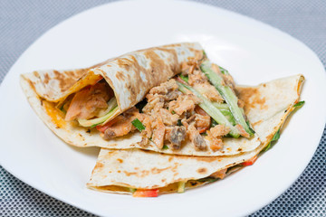pancakes with chicken and vegetables on a white background. Cucumber pepper