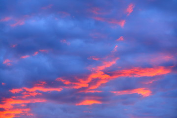 Beautiful orange cloudscape in the late evening with high saturation and using multiple exposure