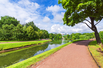 Obraz premium City park with walks for walks, trees and canals