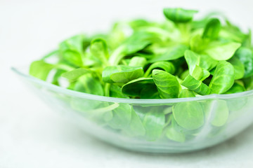 Fresh green salad with spinach In a glass bowl