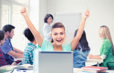 happy student girl with laptop at school