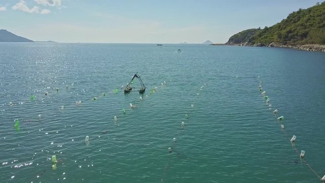 Drone Flies along Fishing Nets against Tropical Landscape