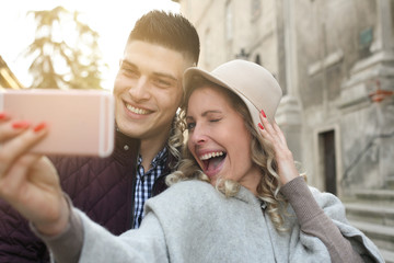 People using technology. Couple making self-picture together.