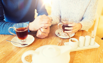 close up of couple drinking tea at cafe
