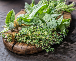 Fresh herbs on the wooden table.