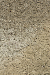 Detail of a beige structured plaster wall
