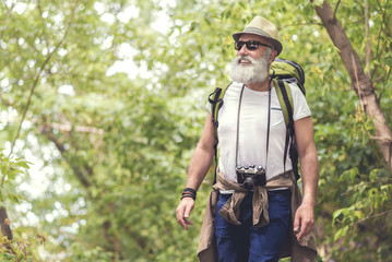 Excited old man traveling in the nature