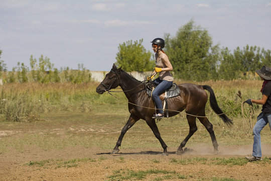 Horseback Riding Lessons - Young Woman Riding A Horse