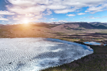 Northern landscape. The lake is ice-covered. Impenetrable swamps in the north