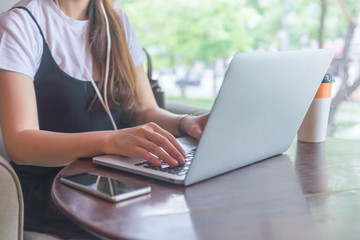 Close up of young woman hand using laptop