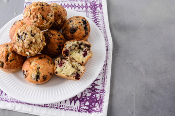 Muffins with blueberries on a white plate.