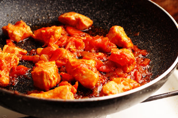 Stewed meat in tomato sauce in the pan