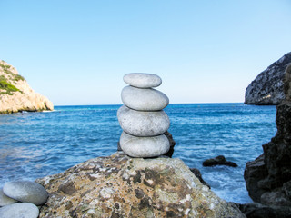 Stack of balancing pebbles with the sea in the background