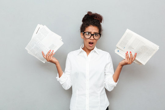 African Confused Business Woman Standing Over Grey Wall