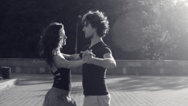 Young couple dancing on the square