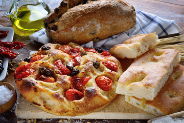 Focaccia with cherry tomatoes and olives, olive bread and white focaccia,