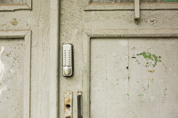 Outdoor intercom on an old cracked door
