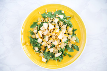pear salad arugula pine nuts top view