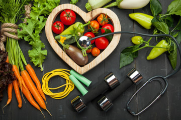 Fresh vegetables in the heart. Diet, healthy lifestyle on a black background