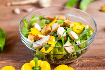 chicken salad bowl on kitchen table, balanced diet