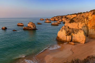 Naklejka premium Sunrise at Praia da Donna Anna, coastline in Algarve, Portugal