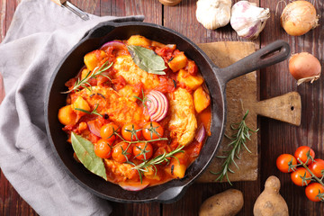 chicken cooked with tomato sauce and herbs