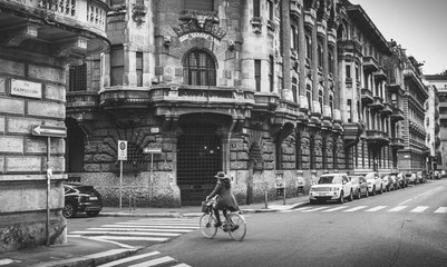 Unidentifable woman on a bike in Milan's Porta Venezia district
