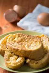 French toast on the plate with egg and eggshells in the background