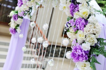 Lilac wedding arch with glass balls with flowers inside